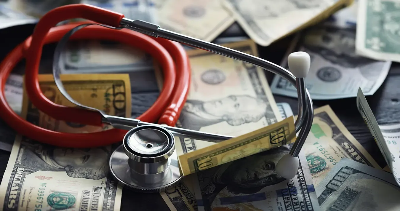 Image of a stethoscope on dollar bills